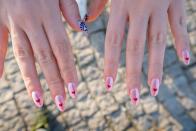 <p>This sweet design showcases long oval nails with a heart on each tip. DIY them if you have a steady hand, or go with decals for an easier option.</p>