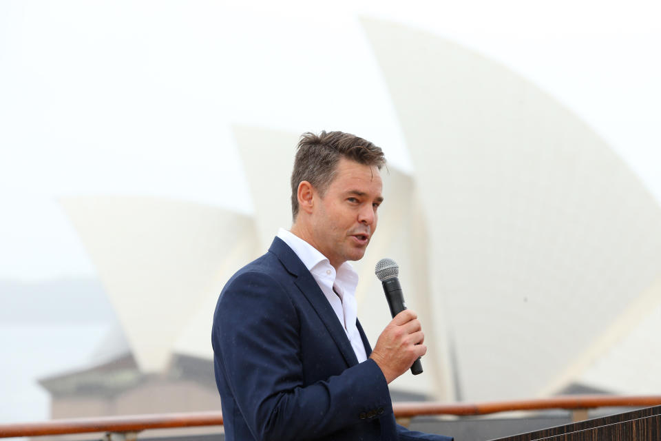 Todd Woodbridge speaks in front of the Sydney Opera House.