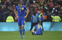 Ukraine's Vitaliy Mykolenko, left, and Ukraine's Mykhailo Mudryk seen in dejection at the end of the World Cup 2022 qualifying play-off soccer match between Wales and Ukraine at Cardiff City Stadium, in Cardiff, Wales, Sunday, June 5, 2022. Wales won 1-0. (AP Photo/Rui Vieira)