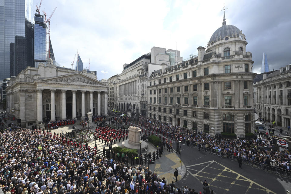 FILE - Crowds listen as the Clarenceux King of Arms reads the Proclamation of Accession of King Charles III at the Royal Exchange in the City of London, Saturday, Sept. 10, 2022. Charles automatically ascended to the throne when Elizabeth died Sept. 8 and he was officially proclaimed Britain’s monarch two days later in an ascension ceremony broadcast for the first time on television. (Leon Neal/Pool Photo via AP, File)