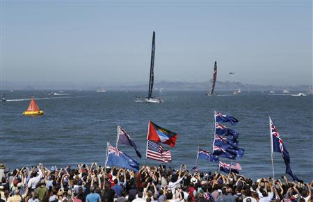 Oracle Team USA (L) sails towards the finish line ahead of Emirates Team New Zealand (R) during Race 12 of the 34th America's Cup yacht sailing race in San Francisco, California September 19, 2013. Oracle Team USA won race 12. REUTERS/Stephen Lam (UNITED STATES - Tags: SPORT YACHTING)
