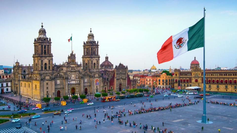 <div class="inline-image__caption"><p>The Mexican flag flies over the Zocalo, the main square in Mexico City. The Metropolitan Cathedral faces the square, also referred to as Constitution Square.</p></div> <div class="inline-image__credit">John Coletti/Getty</div>