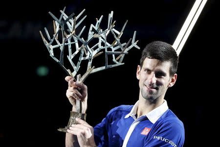 World number one Novak Djokovic of Serbia poses with the trophy after beating Britain's Andy Murray in their men's singles final tennis match at the Paris Masters tennis tournament November 8, 2015. REUTERS/Charles Platiau