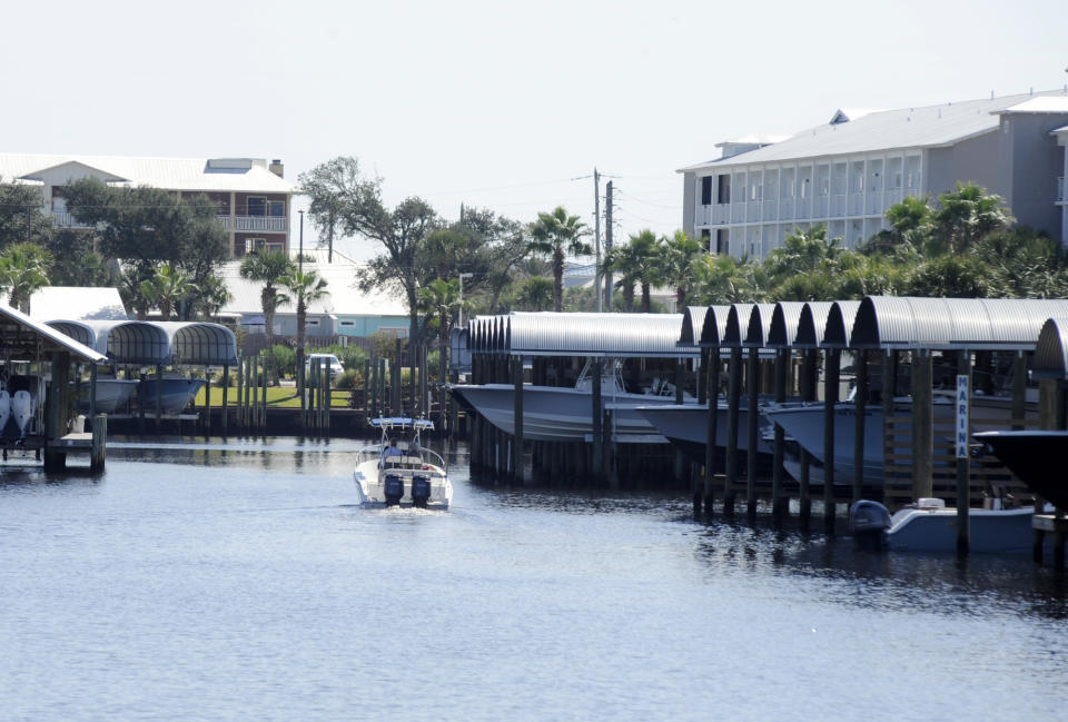 A boat cruises through a marina in rebuilt Mexico Beach, Fla., Tuesday, Oct. 11, 2022. Destroyed by Hurricane Michael, the Florida Panhandle community is still rebuilding four years later. (AP Photo/Jay Reeves)