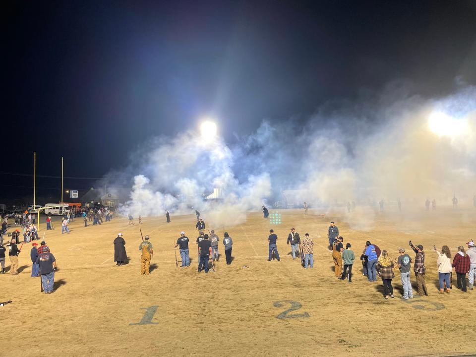 The Cherryville Shooters gather at Rudisill Stadium Monday evening after a traditional day spent shooting muskets around the county to welcome in the new year.