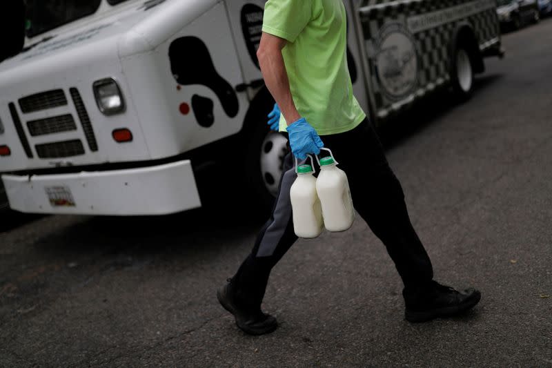 A man delivers milk at Capitol Hill as coronavirus disease (COVID-19) continues to spread in Washington