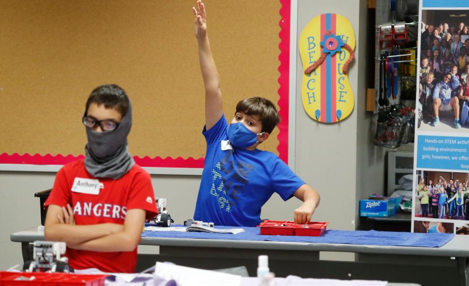 Amid concerns about the spread of COVID-19, Aiden Trabucco, right, and Anthony Gonzales wear face coverings during a summer STEM camp at Wylie High School on July 14 in Wylie, Texas.