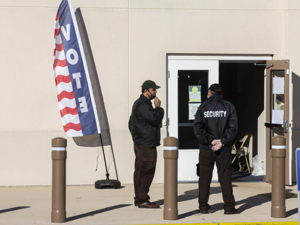 Hired security personnel wait for voters outside the Leon County Supervisor of Elections office on Nov. 3, 2020 in Tallahassee, Florida