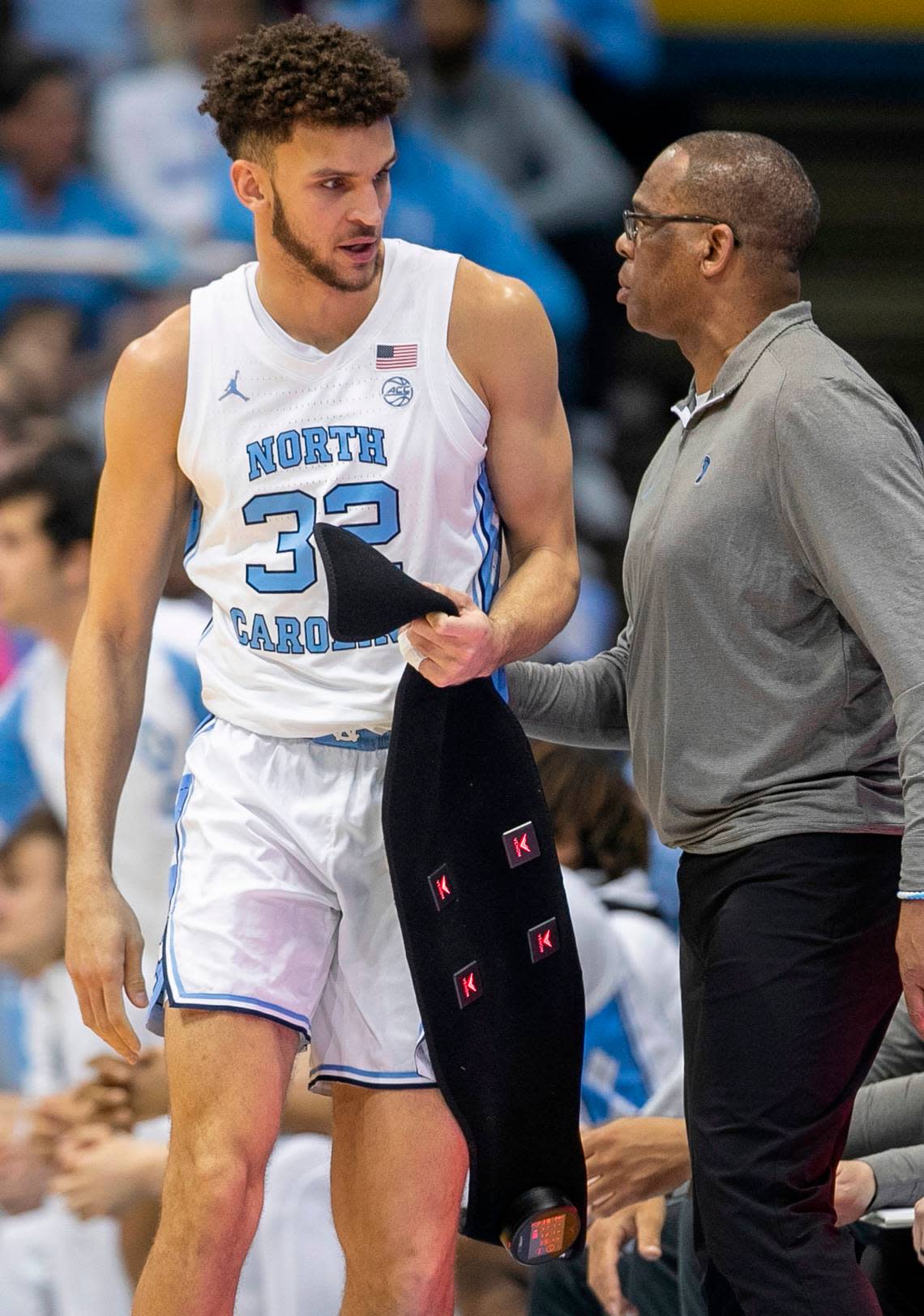 North Carolina’s Pete Nance (32) removes a back support before entering the game against Miami in the first half on Monday, February 13, 2023 at the Smith Center in Chapel Hill, N.C. 