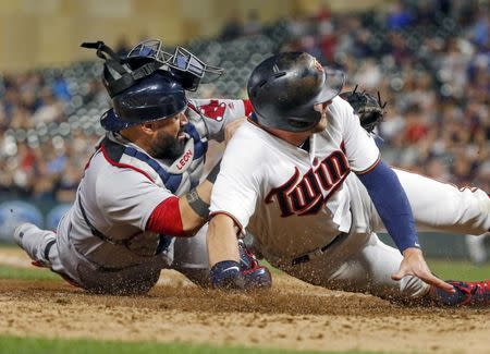 Jun 19, 2018; Minneapolis, MN, USA; Boston Red Sox catcher Sandy Leon (3) tags out Minnesota Twins left fielder Robbie Grossman (36) as he attempts to tag up on a sacrifice fly in the eighth inning at Target Field. Mandatory Credit: Bruce Kluckhohn-USA TODAY Sports