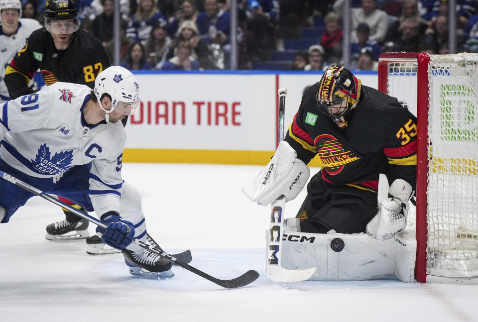 Vancouver Canucks goalie Thatcher Demko, right, stops Toronto Maple Leafs' John Tavares (91) during the third period of an NHL hockey game in Vancouver, British Columbia, Saturday, Jan. 20, 2024. (Darryl Dyck/The Canadian Press via AP)
