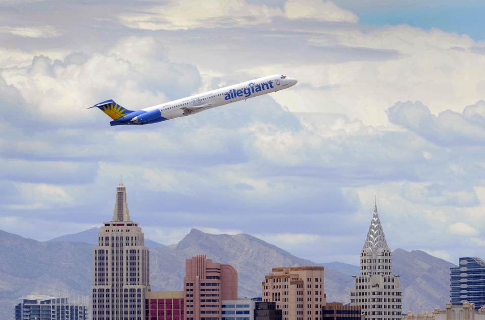 In this Thursday, May 9, 2013, photo, an Allegiant Air jetliner flies over the the the New York-New York Hotel & Casino after taking off from McCarran International Airport in Las Vegas. While other U.S. airlines have struggled with the ups and downs of the economy and oil prices, tiny Allegiant Air has been profitable for 10 straight years. (AP Photo/David Becker)