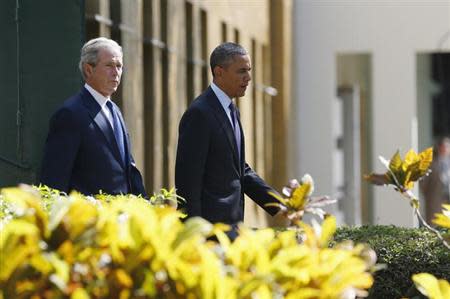 U.S. President Barack Obama and former President George W. Bush attend a memorial for the victims of the 1998 U.S. Embassy bombing in Dar es Salaam July 2, 2013. REUTERS/Jason Reed