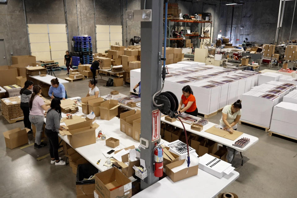 A combination of people and machines makes eclipse glasses at American Paper Optics' manufacturing facility.  (NBC News)