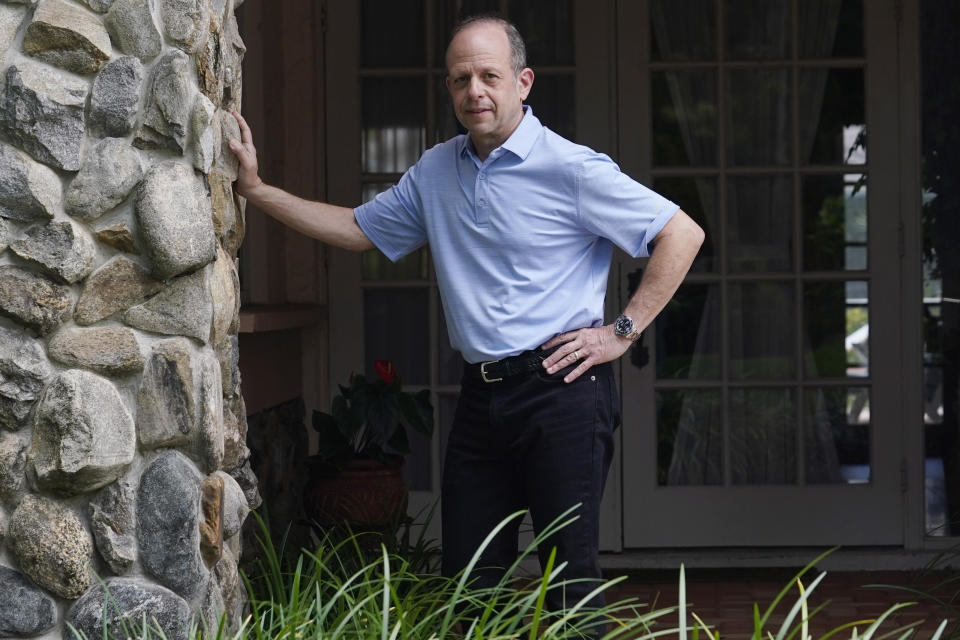 Mark Bendell stands at the entrance to his home, Monday, May 23, 2022, in Boca Raton, Fla. A stock market slump this year, which has taken big bites out of investors’ portfolios, including retirement plans like 401(k)s, is worrying Americans who are within a few years of retirement. Despite the market's decline, investors like Bendell are sticking to their retirement timeline. (AP Photo/Marta Lavandier)