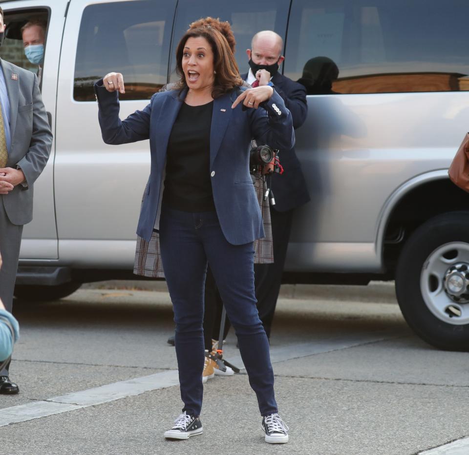 Democratic vice presidential candidate Kamala Harris points to her Chuck Taylor All-Stars during a campaign stop in Milwaukee on Sept. 7, 2020.