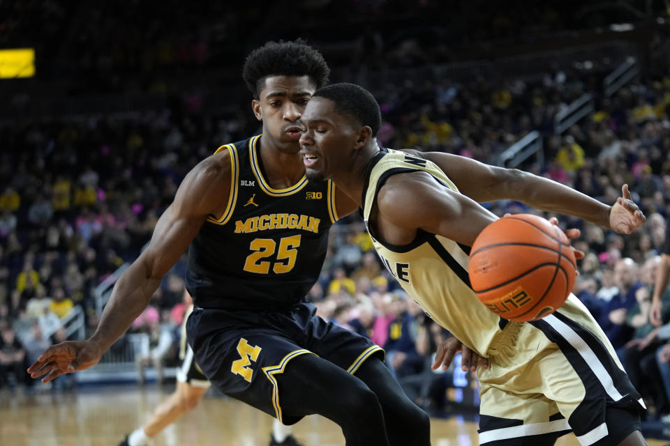 Purdue guard Brandon Newman drives past Michigan guard Jace Howard (25) during the first half of an NCAA college basketball game in Ann Arbor, Mich., Thursday, Jan. 26, 2023. (AP Photo/Paul Sancya)