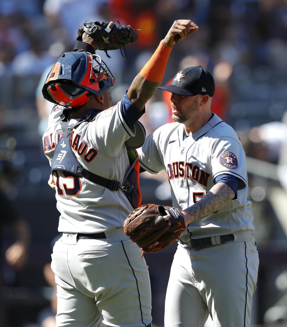 Houston Astros catcher Martin Maldonado (15) and relief pitcher Ryan Pressly (55) celebrate after a combined no-hitter against the New York Yankees in a baseball game,Saturday, June 25, 2022, in New York. The Houston Astros won 3-0. (AP Photo/Noah K. Murray)