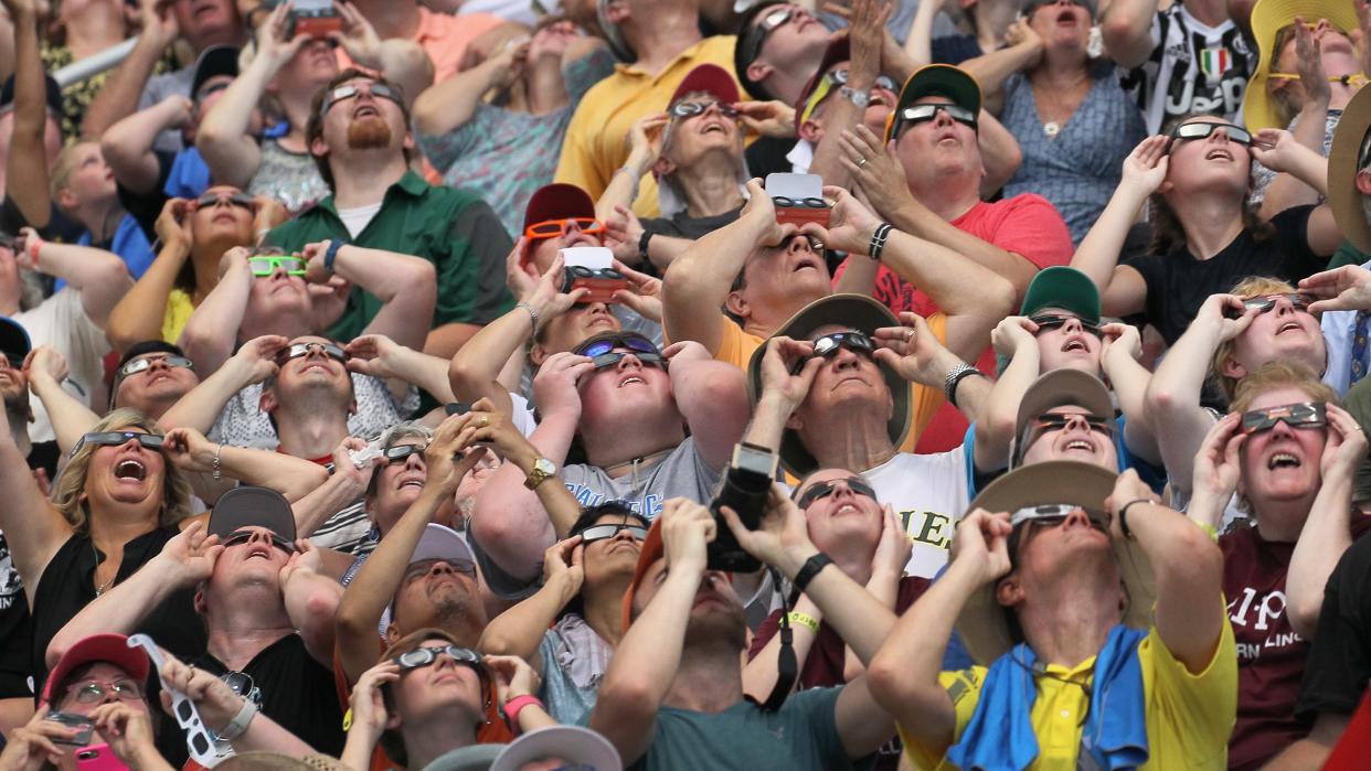   People watch the solar eclipse at Saluki Stadium on the campus of Southern Illinois University on August 21, 2017 in Carbondale, Illinois. 
