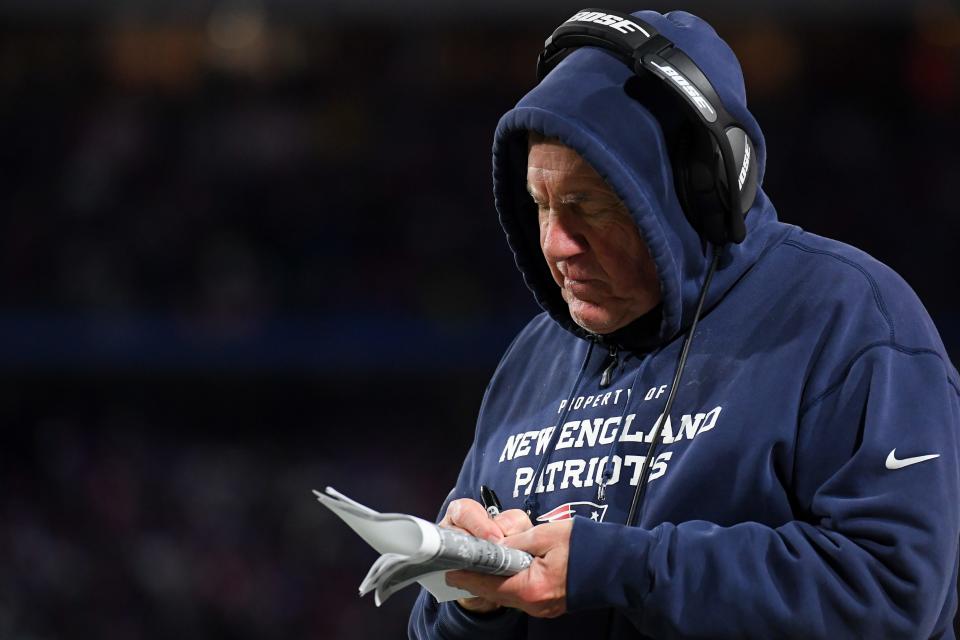 New England Patriots head coach Bill Belichick takes notes against the Buffalo Bills during the first half of a game on Monday, Dec. 6, 2021, at Highmark Stadium in Orchard Park, New York.