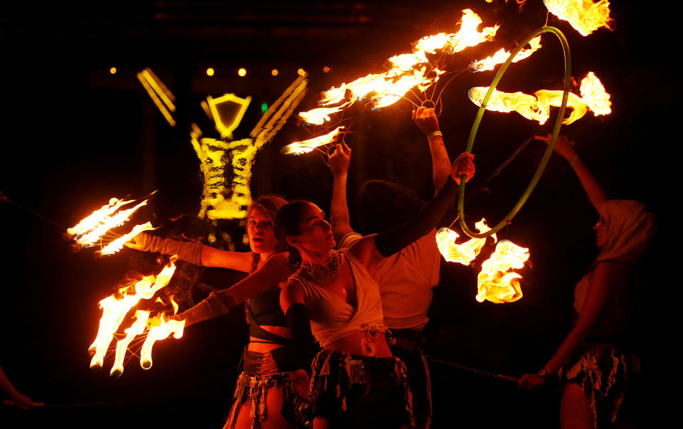 <p>Burning Man participants from the “Revolutionary Motion” fire conclave spin fire in front of the effigy of “The Man” just before the effigy is burned at the culmination of the annual Burning Man arts and music festival in the Black Rock desert of Nevada, Sept. 2, 2017. (Photo: Jim Bourg/Reuters) </p>