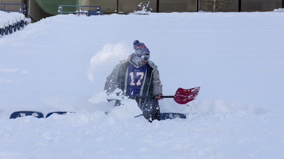 A Buffalo Bills fan clears snow from his row of seats before an NFL wild-card playoff football game between the Buffalo Bills and the Pittsburgh Steelers, Monday, Jan. 15, 2024, in Buffalo, N.Y. (AP Photo/Jeffrey T. Barnes)