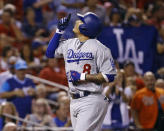 Los Angeles Dodgers' Manny Machado points skyward after hitting a home run off of St. Louis Cardinals relief pitcher John Brebbia during the seventh inning of a baseball game Thursday, Sept. 13, 2018, in St. Louis. (AP Photo/Billy Hurst)