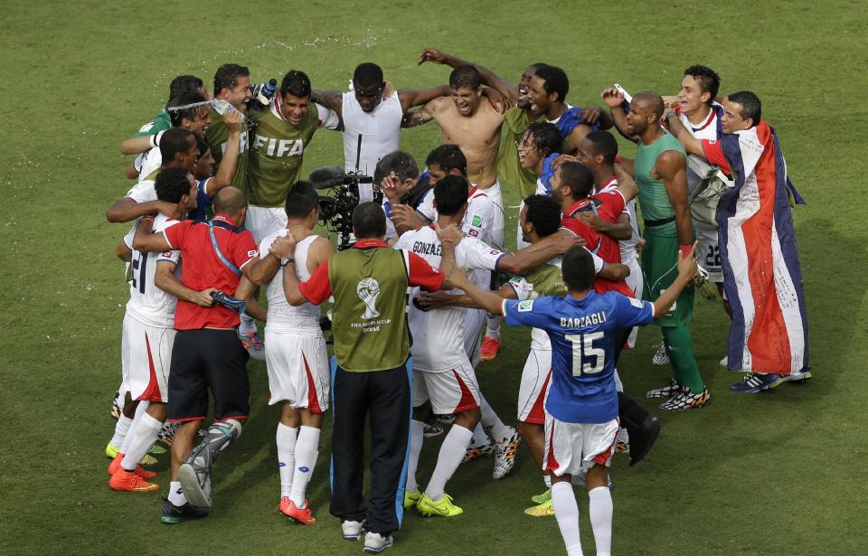 Costa Rica players celebrate after beating Italy. (Hassan Ammar/AP Photo)