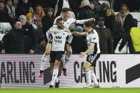 Fulham's Layvin Kurzawa, left, celebrates scoring their side's third goal of the game during the English FA Cup fourth round replay soccer match against Sunderland at the Stadium of Light, Sunderland, England, Wednesday, Feb. 8, 2023. (Owen Humphreys/PA via AP)
