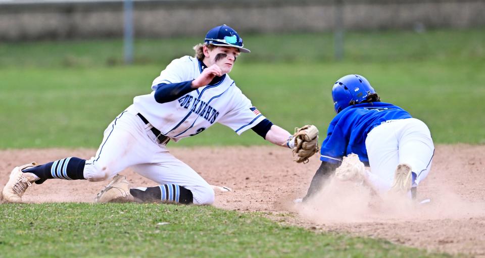 Seamus Vining of Sandwich reaches to tag Brady James of Mashpee at second on Friday, April 7, 2023.