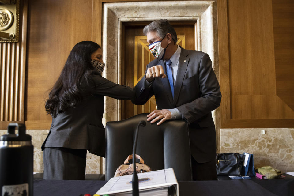 Sen. Joe Manchin, D-W.Va., greets Rep. Deb Haaland, D-N.M., before the start of the Senate Committee on Energy and Natural Resources hearing on her nomination to be Interior Secretary, Tuesday, Feb. 23, 2021 on Capitol Hill in Washington. (Graeme Jennings/Pool via AP)