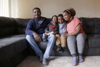 In this photo taken Sept. 24, 2019, Yonas Yeshanew, left, who resigned as Ethiopian Airline's chief engineer this summer and is seeking asylum in the U.S., poses with his family, including wife Tigist Hailu and sons Nathan Yonas, 1, and Yoel Yonas, 5, in the Seattle area. Yeshanew says in a whistleblower complaint filed with regulators that the carrier went into the maintenance records on a Boeing 737 Max jet a day after it crashed this year, a breach he contends was part of a pattern of corruption that included fabricating documents, signing off on shoddy repairs and even beating those who got out of line. (AP Photo/Elaine Thompson)
