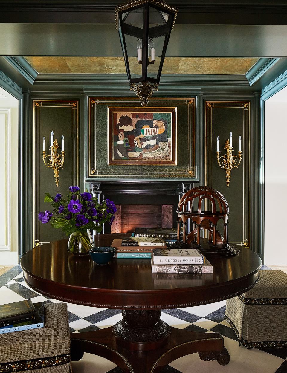 Designed for a family of avid readers, the leather-clad entry—a nod to leather-bound books—with its gilt ceiling and roaring fire provides a warm welcome home to this East Lake Shore Drive apartment in Chicago by Craig & Company. The leather walls were made by Michele Costello of CSI Designs.