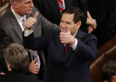 Republican U.S. presidential candidate Senator Marco Rubio (C) gives two thumbs up as he awaits U.S. President Barack Obama's State of the Union address to a joint session of Congress in Washington, January 12, 2016. REUTERS/Jonathan Ernst