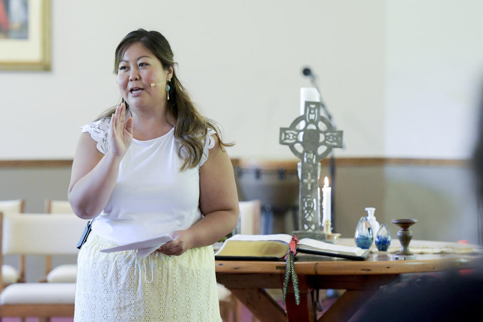 Pastor Juliet Liu of Life on the Vine church closes Sunday services with the sign of the cross on May 22, 2022, in Long Grove, IL. (AP Photo/Mark Black)