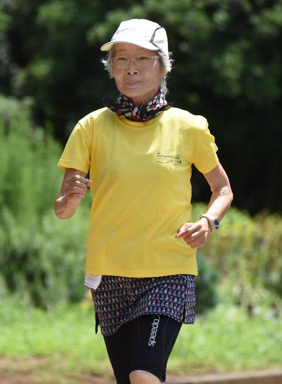 78-year-old Japanese endurance runner Yoko Nakano jogs on the street in Tokyo on July 28, 2014, preparing for her latest world record tilt