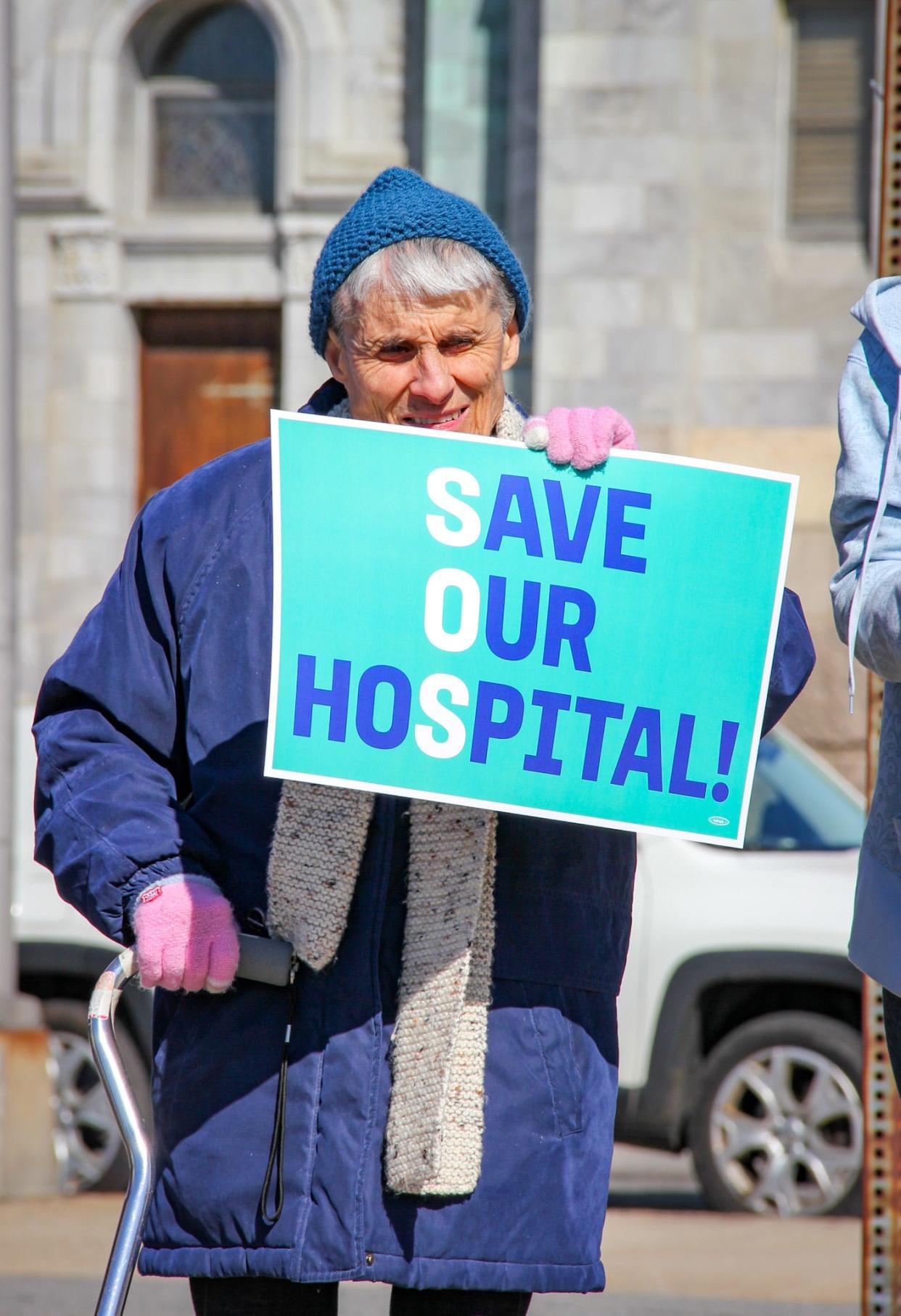 Patricia Silvia of Fall River holds a sign in support of St. Anne's Hospital in Fall River at a rally pushing for secure ownership of Steward Health Care facilities on April 25.