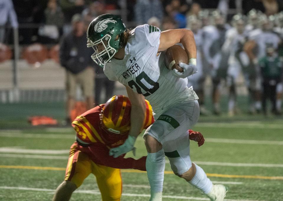 Manteca's Blake Nichelson, right, fends off Oakdale's Jake Kettering during the Sac-Joaquin Section Division III championship game at St. Mary's High School in Stockton. Manteca won 35-28.
