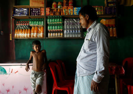 Azimul Hasan, 10, a Rohingya refugee boy, stands inside a roadside hotel where he works at Jamtoli, close to Palong Khali camp, near Cox's Bazar, Bangladesh, November 12, 2017. REUTERS/Navesh Chitrakar