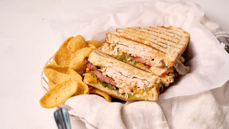 turkey panini with chips on table