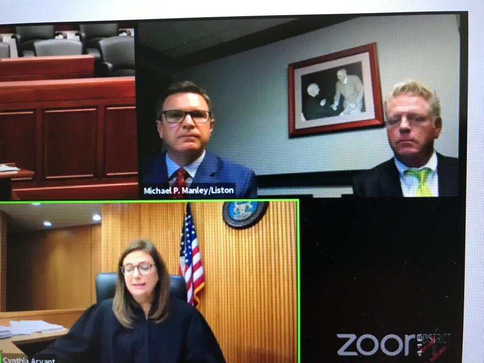 Former Macomb County chief assistant prosecutor Benjamin Liston, far right wearing a green tie, at a plea hearing with his attorney, Michael Manley, and Judge Cynthia Arvant in 41-B District Court in Clinton Township on Sept. 17, 2020.