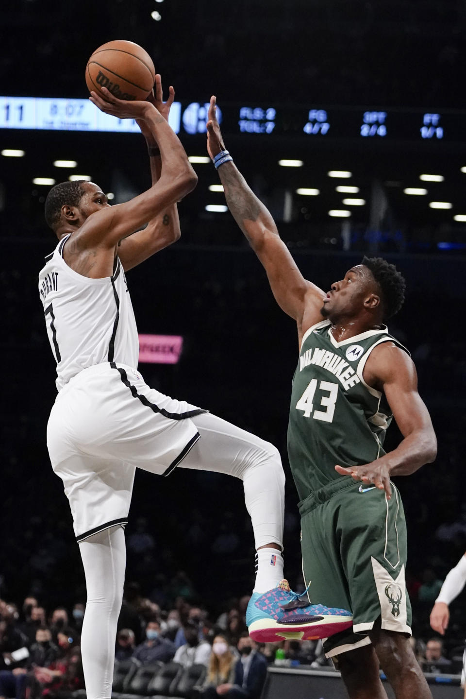 Brooklyn Nets' Kevin Durant (7) shoots over Milwaukee Bucks' Thanasis Antetokounmpo (43) during the first half of a preseason NBA basketball game Friday, Oct. 8, 2021, in New York. (AP Photo/Frank Franklin II)