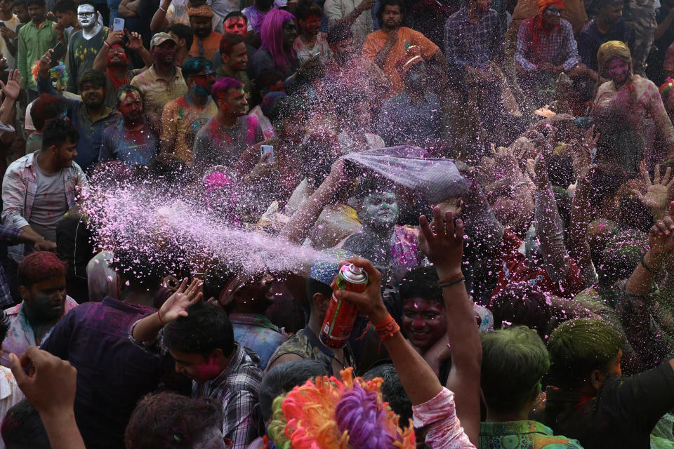 People take part in the celebrations to mark Holi, the Hindu spring festival of colors at Assi Ghat in Varanasi on March 25, 2024. / Credit: NIHARIKA KULKARNI/AFP via Getty Images