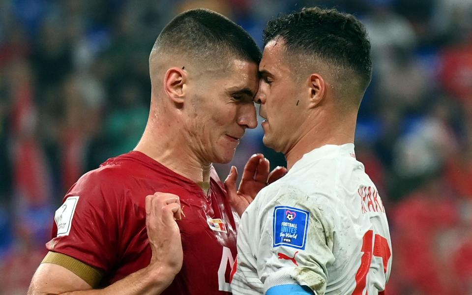 Nikola Milenkovic (L) of Serbia and Xherdan Shaqiri of Switzerland scuffle - SHUTTERSTOCK