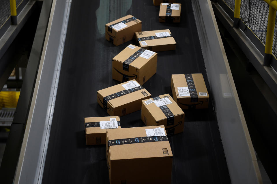 Boxes ready to be loaded onto a delivery truck move along a conveyor belt at the Amazon fulfilment centre in Baltimore, Maryland, U.S., April 30, 2019. REUTERS/Clodagh Kilcoyne
