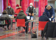 People register to receive a COVID-19 vaccination in Montreal, Thursday, December 23, 2021, as the COVID-19 pandemic continues in Canada and around the world. (Graham Hughes /The Canadian Press via AP)