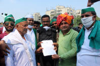 Bharatiya Kisan Union (BKU) members are seen handing over a letter with their demands to Kumar Ranvijay, Additional DCP, Noida at the Delhi-Noida border in protest against the farms bills passed by Modi government on September 25, 2020 in Noida, India. Farmers from different villages gathered to march to Delhi as part of a nationwide protest all across the country. (Photo by Mayank Makhija/NurPhoto via Getty Images)