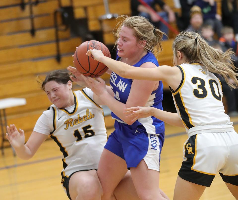 Tuslaw's Breanna McCabe, center, and Crestview's Lexi Blower, left, and Brianna DiCross battle for a loose ball Wednesday.