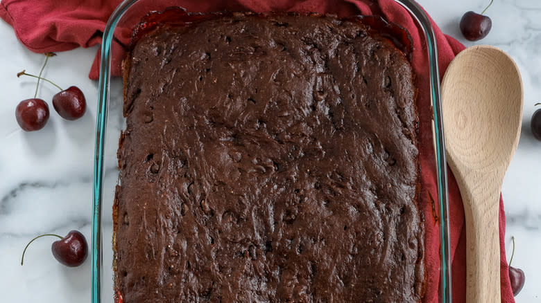 cherry cola dump cake in a pan on a table