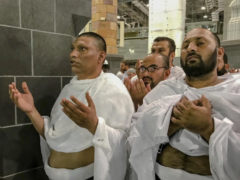 Muslim pilgrims pray inside the Grand Mosque, ahead of the annual Hajj pilgrimage in the Muslim holy city of Mecca, Saudi Arabia, Friday, Aug. 17, 2018. The annual Islamic pilgrimage draws millions of visitors each year, making it the largest yearly gathering of people in the world. (AP Photo/Dar Yasin)